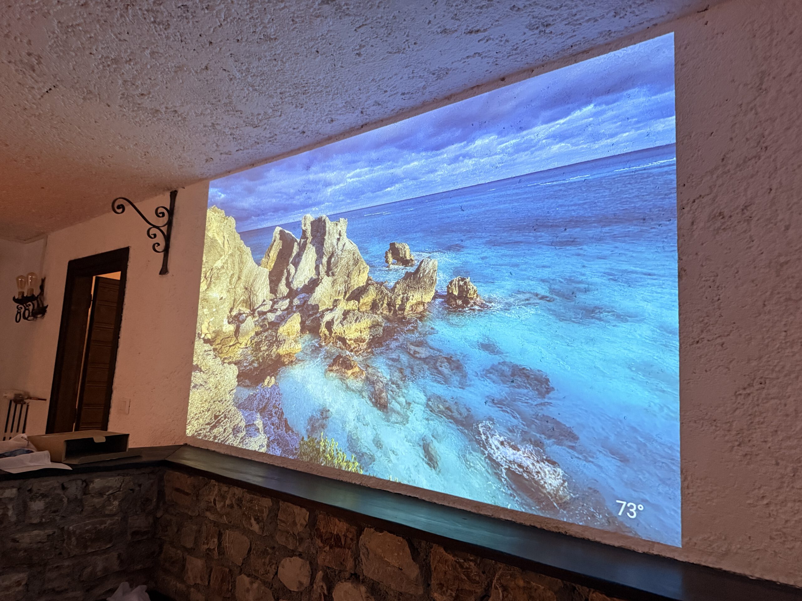 Large-format projection wall on the taverna level, next to the cinema room